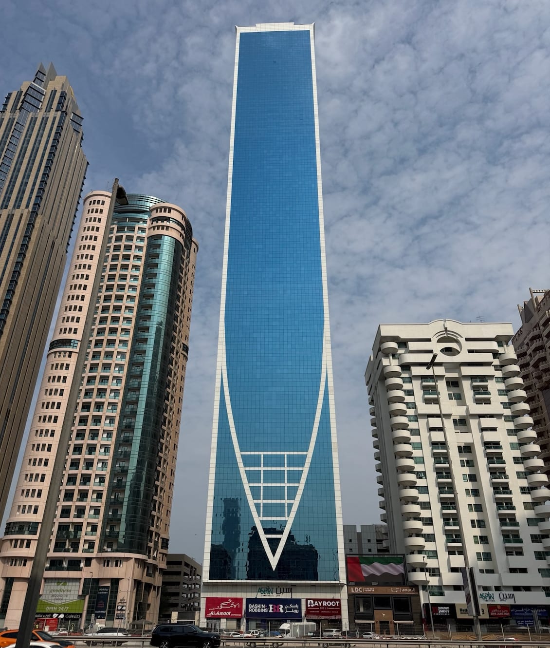 Aspin Commercial Tower's angled glass facade on Sheikh Zayed Road, Dubai